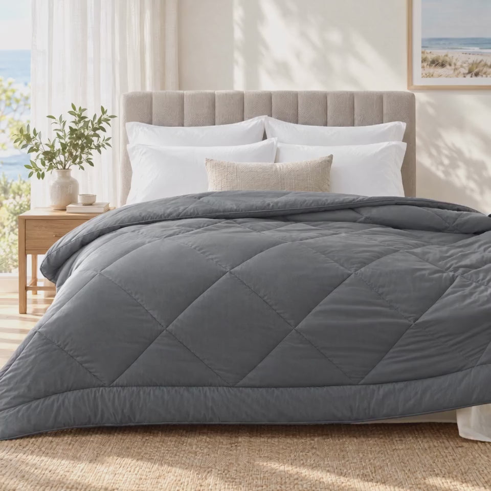 Coastal Grey quilt flicked across the bed and smoothed flat